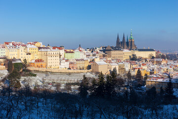 Christmas Snowy Prague City with gothic Castle from Hill Petrin in the sunny Day, Czech republic