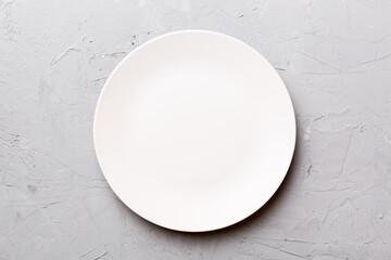 Top view of empty light plate on cement background. Empty space for your design