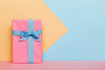 holiday handmade paper present tied blue ribbon bow top view with copy space. Flat lay holiday...