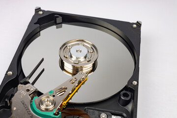 Disassembled hard drive from the computer, hdd with mirror effect close up. Opened hard drive from the computer hdd with mirror effects. Part of computer pc, laptop. 