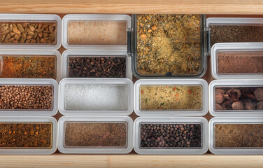 plastic containers with dry spices on a kitchen