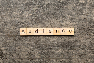 AUDIENCE word written on wood block. AUDIENCE text on cement table for your desing, concept