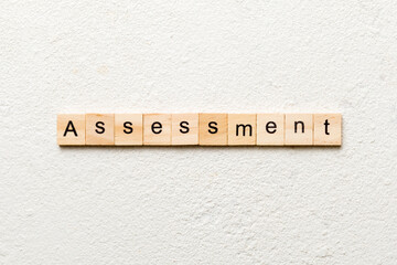 assessment word written on wood block. assessment text on table, concept