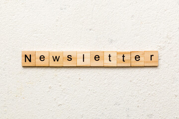 newsletter word written on wood block. newsletter text on table, concept