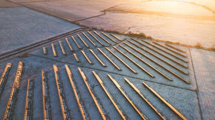 Aerial view of the solar panels. Flight over the snowy fields. 
