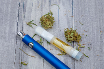 CDB. Cannabis oil extract In Vape pen cartridge and marijuana buds. Medicinal weed