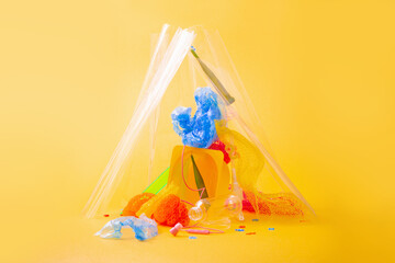 plastic trash on bright yellow background