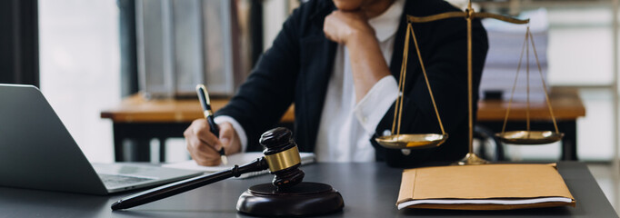 Male lawyer working with contract papers and wooden gavel on tabel in courtroom. justice and law ,attorney, court judge, concept.