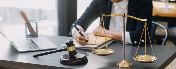 Male lawyer working with contract papers and wooden gavel on tabel in courtroom. justice and law ,attorney, court judge, concept.