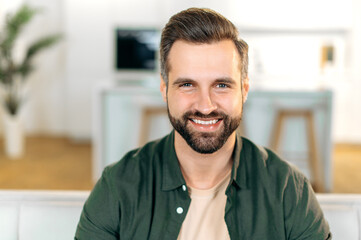 Photo of a handsome charismatic attractive caucasian bearded man, wearing a stylish casual shirt,...