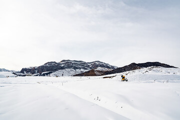 Fototapeta na wymiar Snow capped mountains with ski tracks