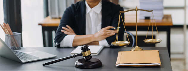 law books and scales of justice on desk in library of law firm. jurisprudence legal education concept.