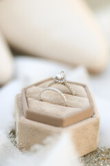 Bride diamond wedding ring and engagement band in a cream velvet ring box