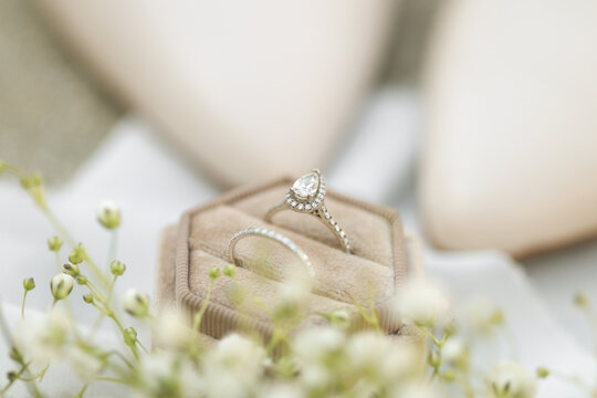 Bride diamond wedding ring and engagement band in a cream velvet ring box