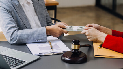 law books and scales of justice on desk in library of law firm. jurisprudence legal education concept.