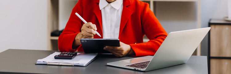 Businessman and team analyzing financial statement Finance task. with smart phone and laptop and...