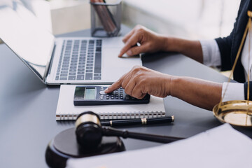 Business and lawyers discussing contract papers with brass scale on desk in office. Law, legal services, advice, justice and law concept picture with film grain effect