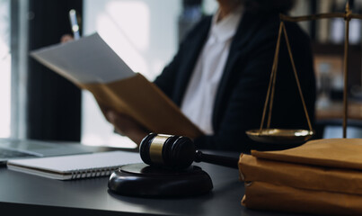 Justice and law concept.Male judge in a courtroom with the gavel, working with, computer and...