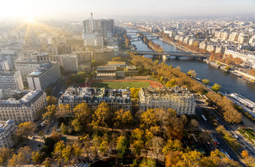 Beautiful panoramic view above historical Parisian buildings from the Eiffel Tower. Scenery of Paris and Seine River. Aerial view of roofs.