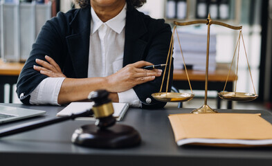 justice and law concept.Male judge in a courtroom on wooden table and Counselor or Male lawyer working in office. Legal law, advice and justice concept.