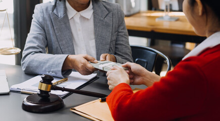 law books and scales of justice on desk in library of law firm. jurisprudence legal education concept.