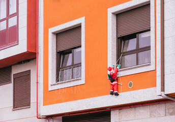 Santa Claus climbing out of the window on the stairs