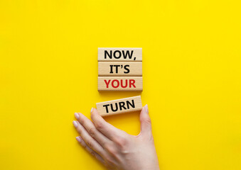 Now it's your turn symbol. Concept words Now it's your turn on wooden blocks. Beautiful yellow...
