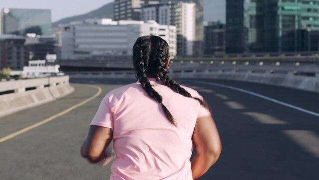 Fitness, health and overweight woman in a road for running, wellness and body goal in city from behind. Exercise, plus size and girl runner with motivation for change, training and goals in New York