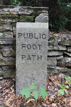 Stone marking a public foot path; Ampney Crucis, Cotswolds, England