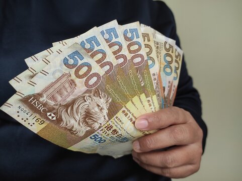 500 Hong Kong dollars banknote in human hand isolated at home no face.