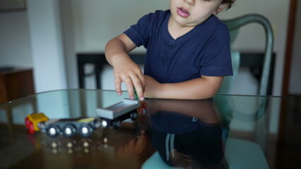 Kid plays with train toy at home candid playful child