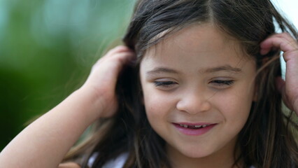 Fototapeta premium Adorable small girl portrait face with milk teeth missing smiling child