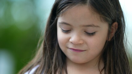 Cute little girl portrait pensive child closeup standing outside