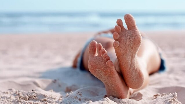 Feet, sand and beach in relax for summer vacation, travel or holiday trip in the outdoors. Bare foot, toes and relaxing lying on the sandy ocean coast for sun tan, weekend break or getaway on mockup