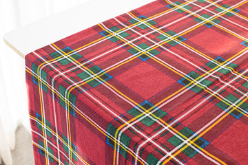 Red and green rustic plaid fabric swatch textile background.