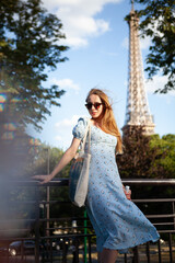 Young beautiful Parisian woman near the Eiffel Tower 