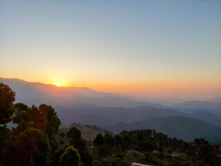 Beautiful sunrise over the mountains. First morning rays of sun in mountains.