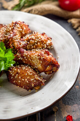 chicken wings in barbecue sauce with sesame vertical