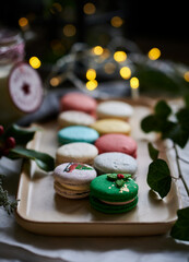 Christmas macarons with milk mug jar and background bokeh lights