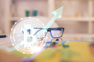 Crypto theme hologram with glasses on the table background. Concept of blockchain. Double exposure.