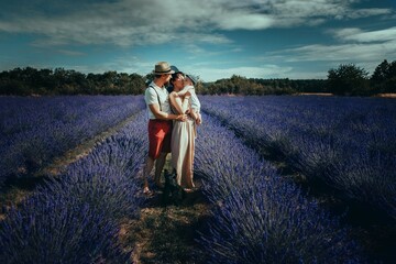 Young family with a small child posing in a lavender field