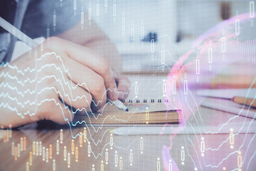 Multi exposure closeup hands with stock market forex graph.