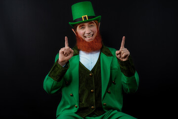 Leprechaun elf on St. Patrick's Day. Cheerful character Irish leprechaun for advertising with a red...