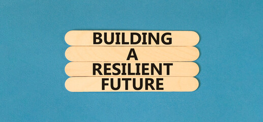 Building a resilient future symbol. Concept word Building a resilient future on wooden sticks....