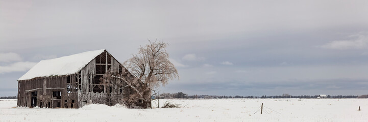 Dilapidated barn covered with snow and ice in winter; Sault St. Marie, Michigan, United States of America