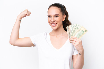 Young caucasian woman taking a lot of money isolated on white background doing strong gesture