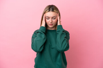 Fototapeta premium Young caucasian woman isolated on pink background with headache