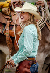 A lovely young cowgirl in the staging area  preparing for her ride in the Cowboy Symposium Parade of the Horse.  © David