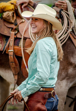 A lovely young cowgirl in the staging area  preparing for her ride in the Cowboy Symposium Parade of the Horse. 