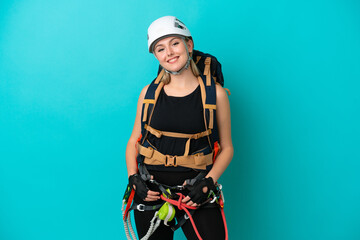 Young caucasian rock climber woman isolated on blue background laughing